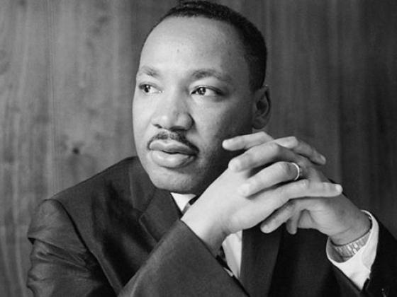 Martin Luther King Jr. with hands clasped